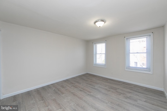 empty room with light hardwood / wood-style floors