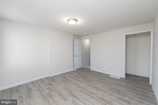 spare room with light hardwood / wood-style floors