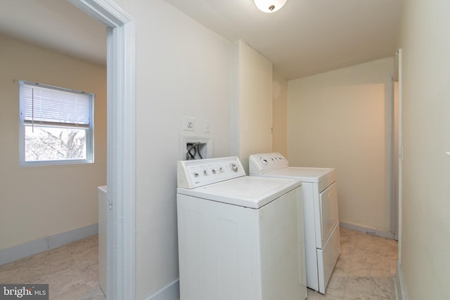 laundry room with hookup for a washing machine, light tile flooring, and washer and dryer