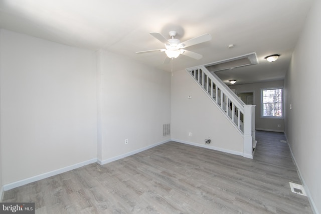 empty room with ceiling fan and light wood-type flooring