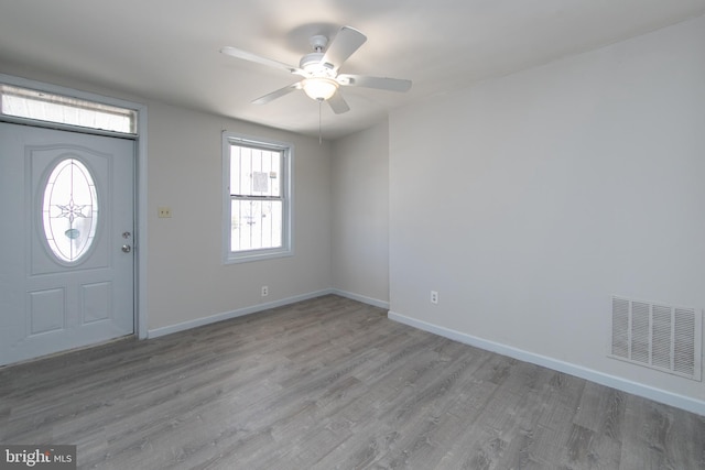 foyer entrance with ceiling fan and light hardwood / wood-style flooring