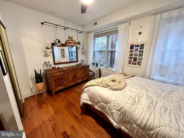 bedroom with hardwood / wood-style flooring and ceiling fan