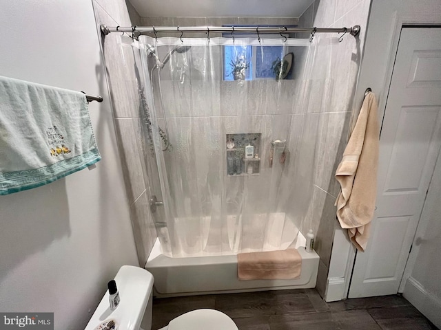 bathroom with shower / bath combo and toilet