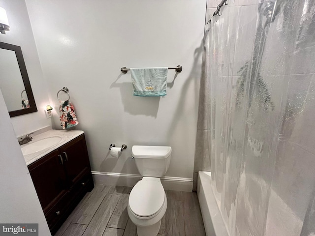 full bathroom with vanity, shower / tub combo, hardwood / wood-style flooring, and toilet