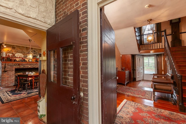 hall featuring hardwood / wood-style floors and vaulted ceiling