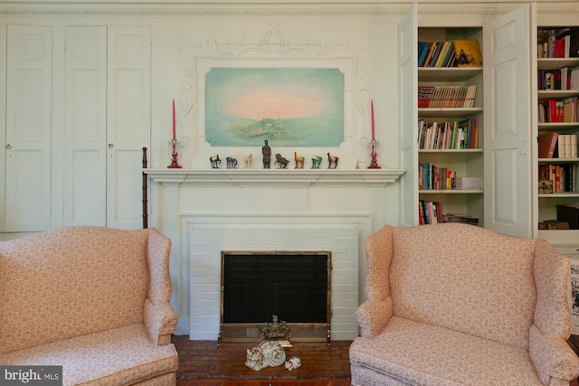 living area featuring a fireplace, hardwood / wood-style floors, and built in shelves