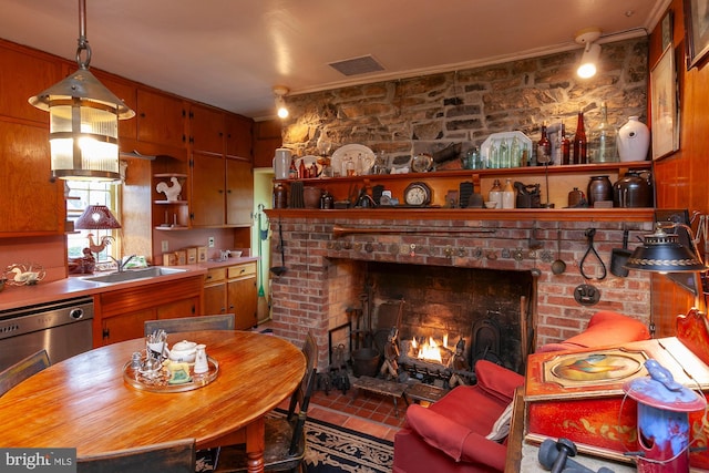 interior space with crown molding, sink, tile patterned flooring, and a brick fireplace