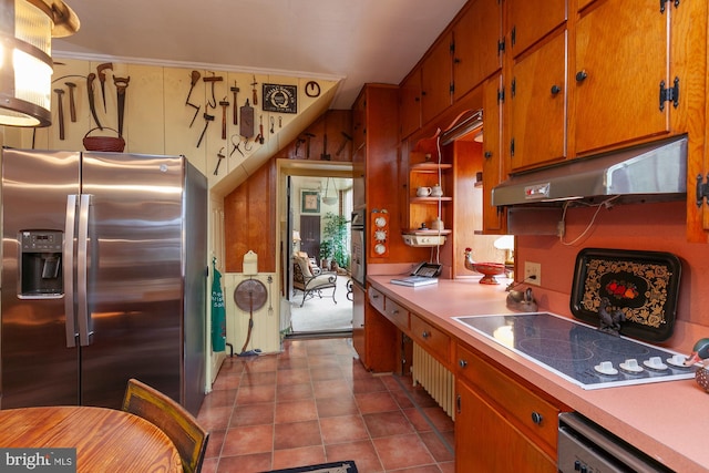 kitchen featuring light tile patterned flooring, ornamental molding, and appliances with stainless steel finishes