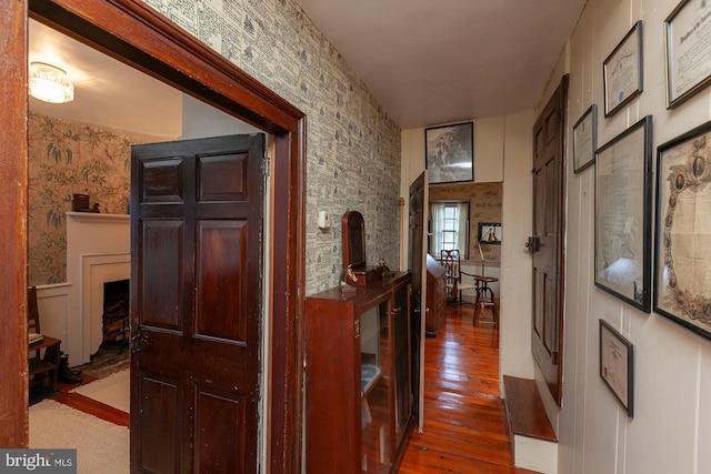 corridor with hardwood / wood-style flooring