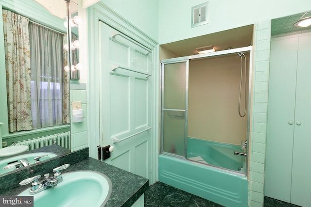 bathroom with vanity and bath / shower combo with glass door