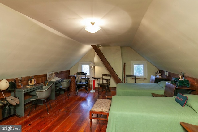 bedroom with dark hardwood / wood-style floors, multiple windows, and lofted ceiling