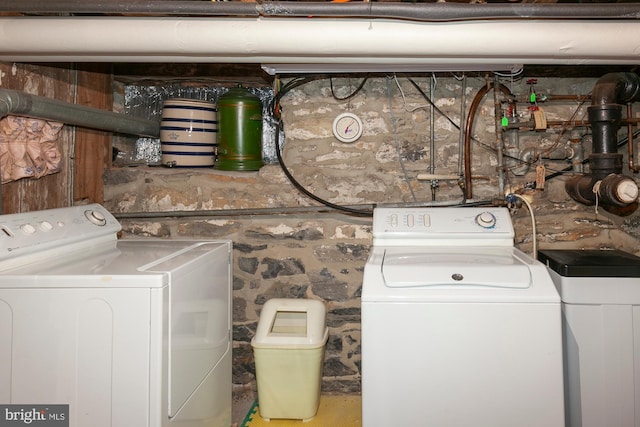 clothes washing area with washer and clothes dryer