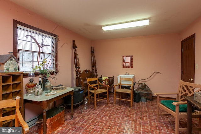 living area with sink and a baseboard heating unit