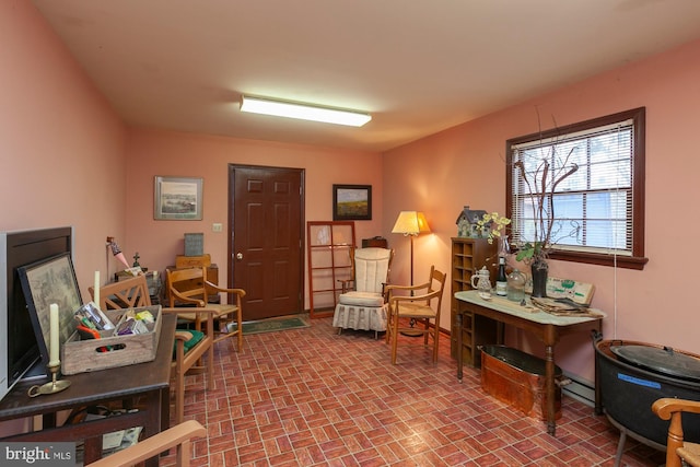 sitting room with a baseboard heating unit