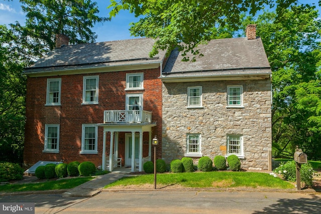 colonial-style house featuring a balcony