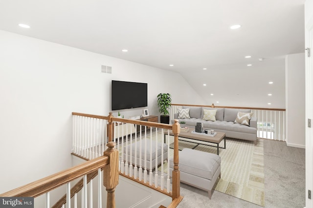 carpeted living room with lofted ceiling