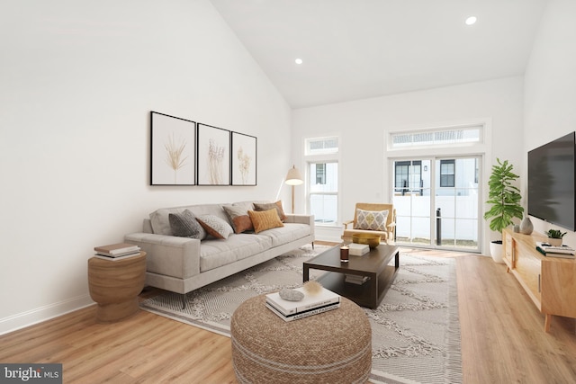 living room featuring light hardwood / wood-style floors and high vaulted ceiling