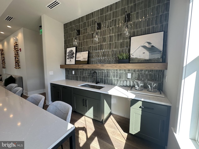 kitchen featuring backsplash, sink, and dark hardwood / wood-style flooring