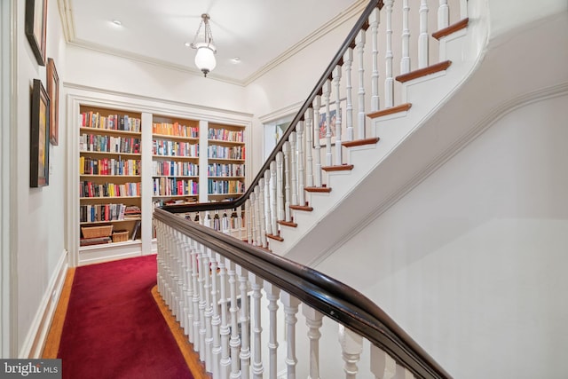 stairs featuring crown molding