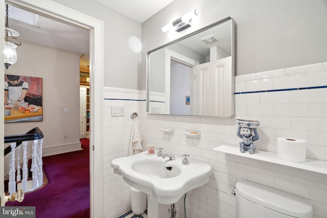 bathroom featuring tile walls, sink, tasteful backsplash, and toilet