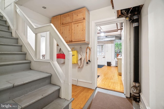 stairs with light hardwood / wood-style floors