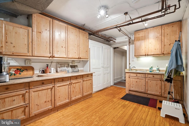 kitchen featuring light brown cabinetry, sink, and light hardwood / wood-style floors