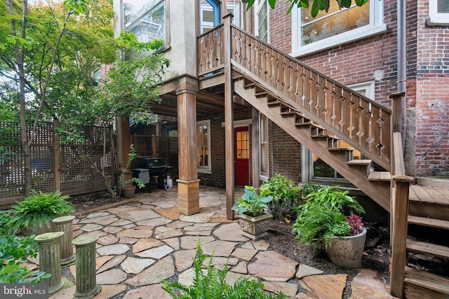 view of patio featuring a wooden deck and grilling area