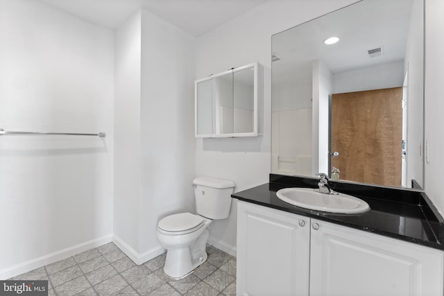 bathroom featuring vanity, tile flooring, and toilet