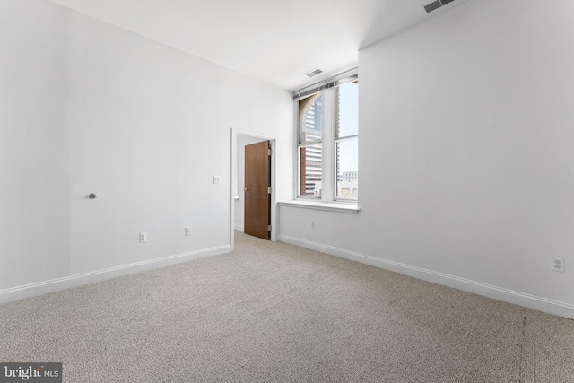 unfurnished room with light colored carpet