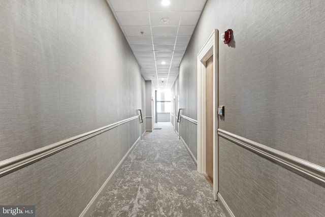 corridor featuring a paneled ceiling