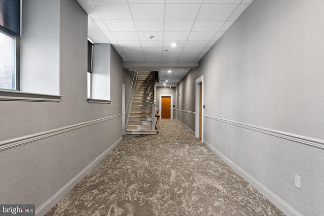 hallway featuring a drop ceiling