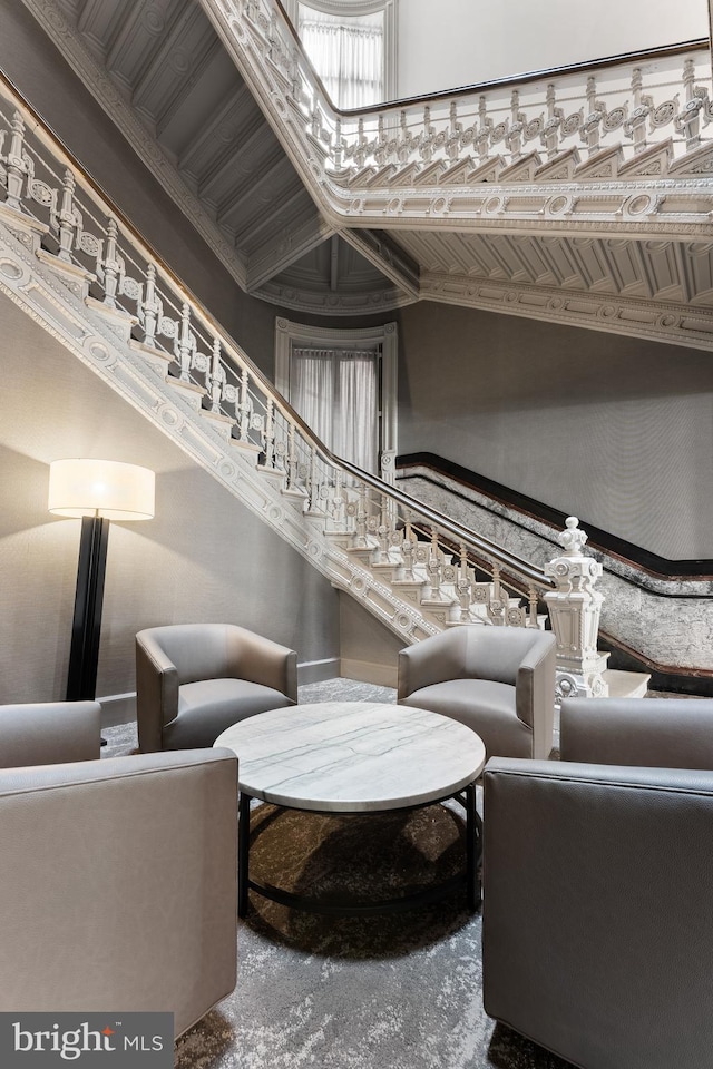 living area featuring a towering ceiling