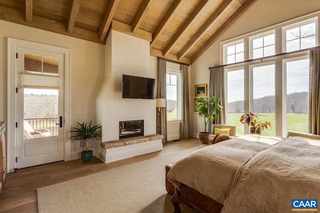 bedroom featuring access to outside, high vaulted ceiling, beamed ceiling, wood ceiling, and light hardwood / wood-style floors