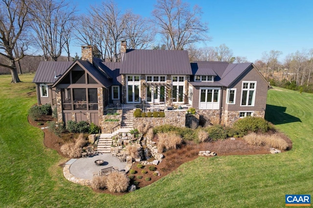 rear view of property featuring a patio, a yard, and a sunroom