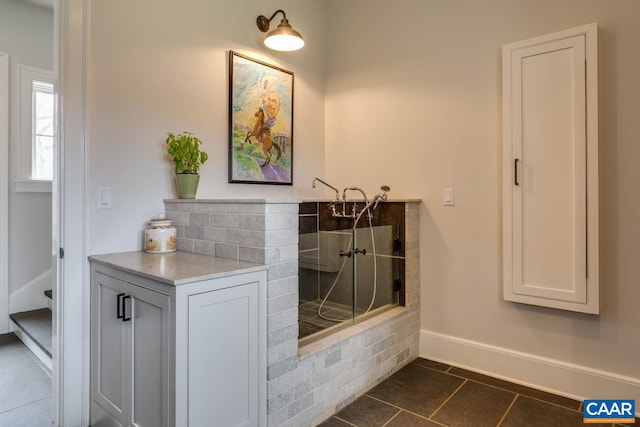 bathroom featuring a shower, tile flooring, and vanity