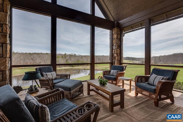 sunroom / solarium featuring a water view, plenty of natural light, vaulted ceiling, and wood ceiling