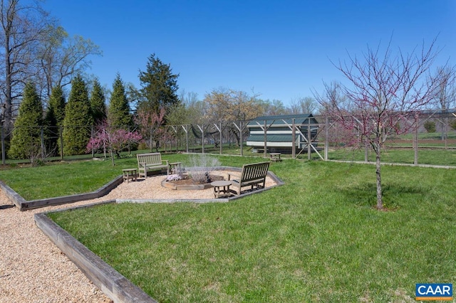 view of yard featuring an outdoor fire pit