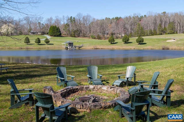 view of yard with an outdoor fire pit and a water view