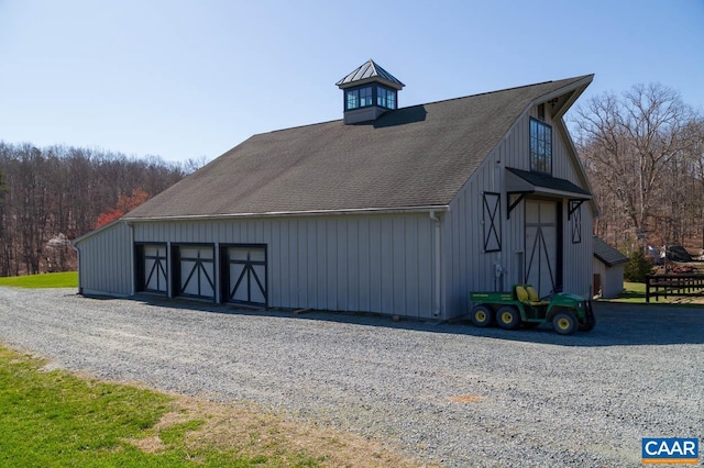 view of side of property with an outdoor structure and a garage