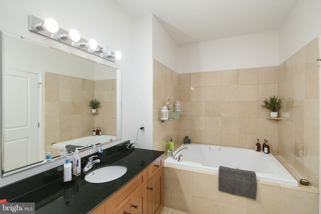 bathroom featuring tiled bath and vanity