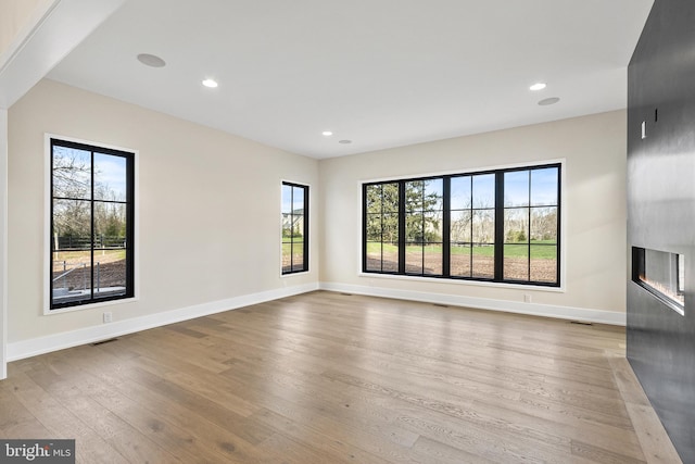 spare room with light wood-type flooring