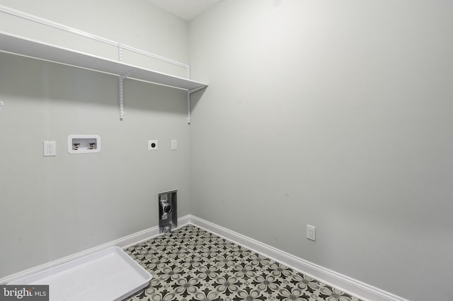 washroom with hookup for a washing machine, electric dryer hookup, and dark tile floors