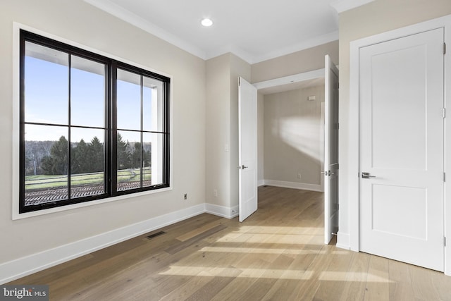 unfurnished bedroom with light hardwood / wood-style flooring and ornamental molding