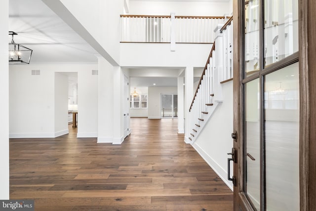 entrance foyer featuring dark hardwood / wood-style floors and an inviting chandelier