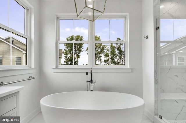 bathroom with vanity, a wealth of natural light, and separate shower and tub