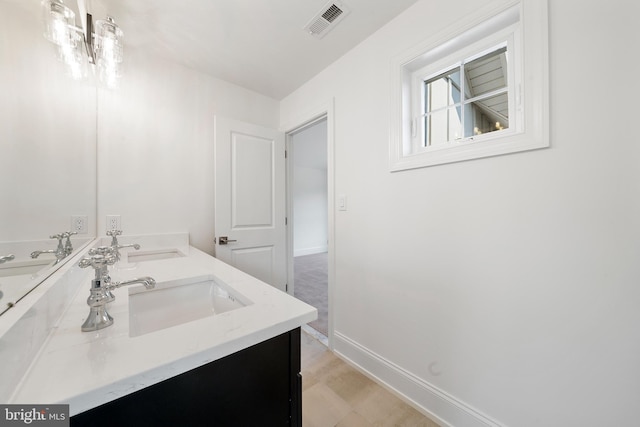 bathroom with an inviting chandelier, tile flooring, and dual vanity