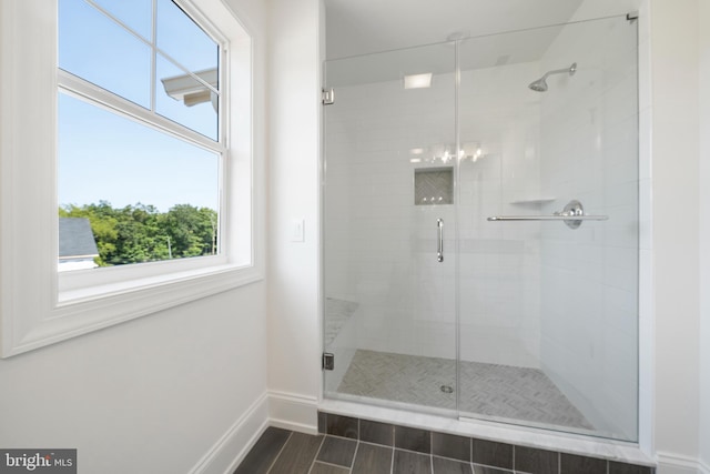 bathroom featuring walk in shower and tile flooring