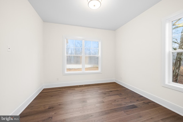 empty room featuring dark wood-type flooring