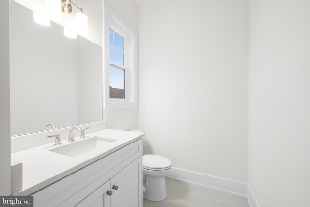 bathroom featuring tile flooring, toilet, and vanity