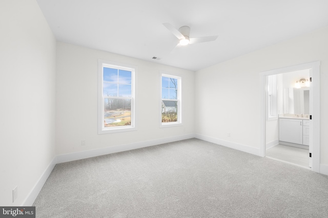 carpeted empty room featuring ceiling fan